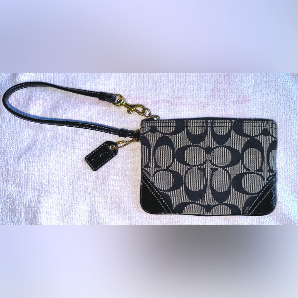 Coach signature black and gray zip wristlet with gold accents and black leather